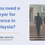 Article header for Do you need a lawyer for a divorce in Malaysia featuring two lawyers in court attire walking up the stone steps toward the entrance of a courthouse